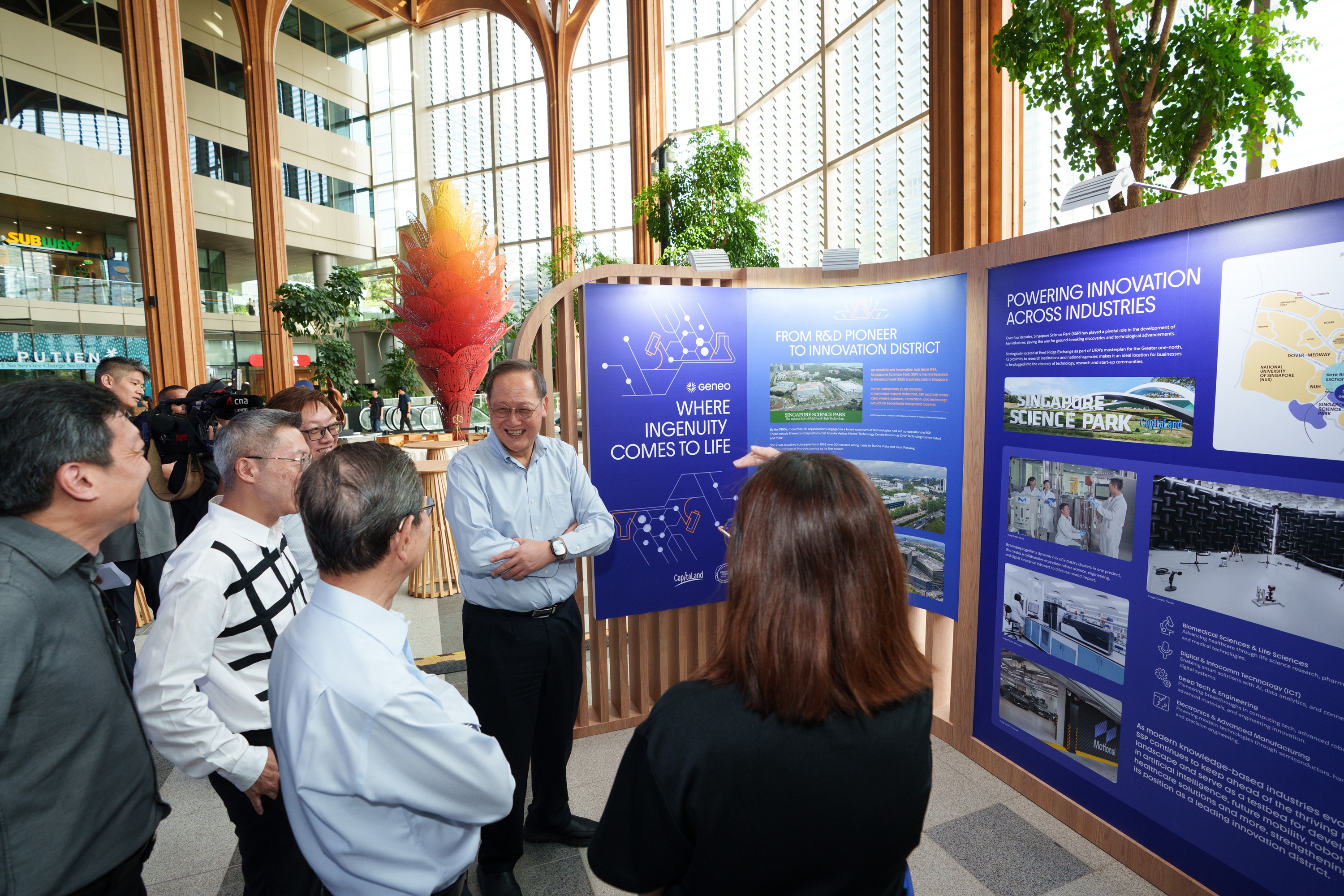Minister Tan See Leng viewing the exhibition panels on Geneo's journey